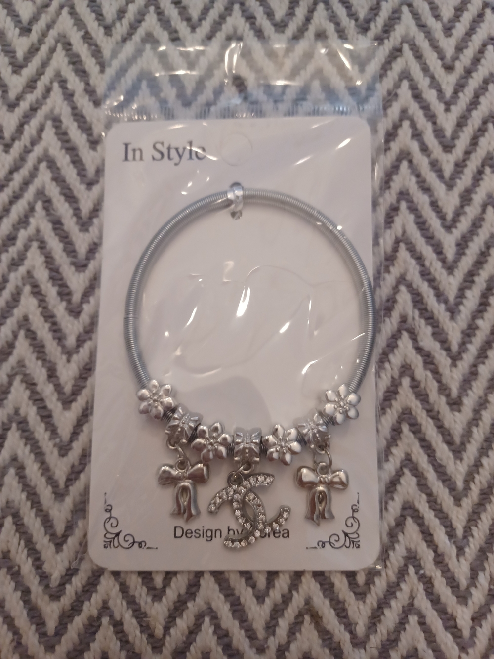 Silver Charm Bracelet with Crystal Logo and Floral Accents